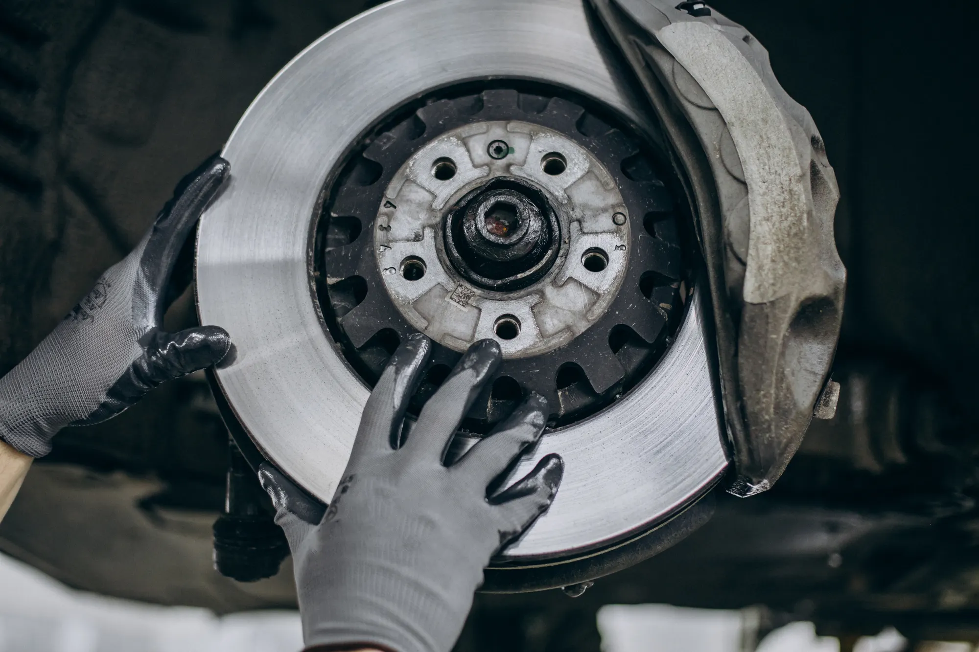 Brake disc and pads being replaced on a European car